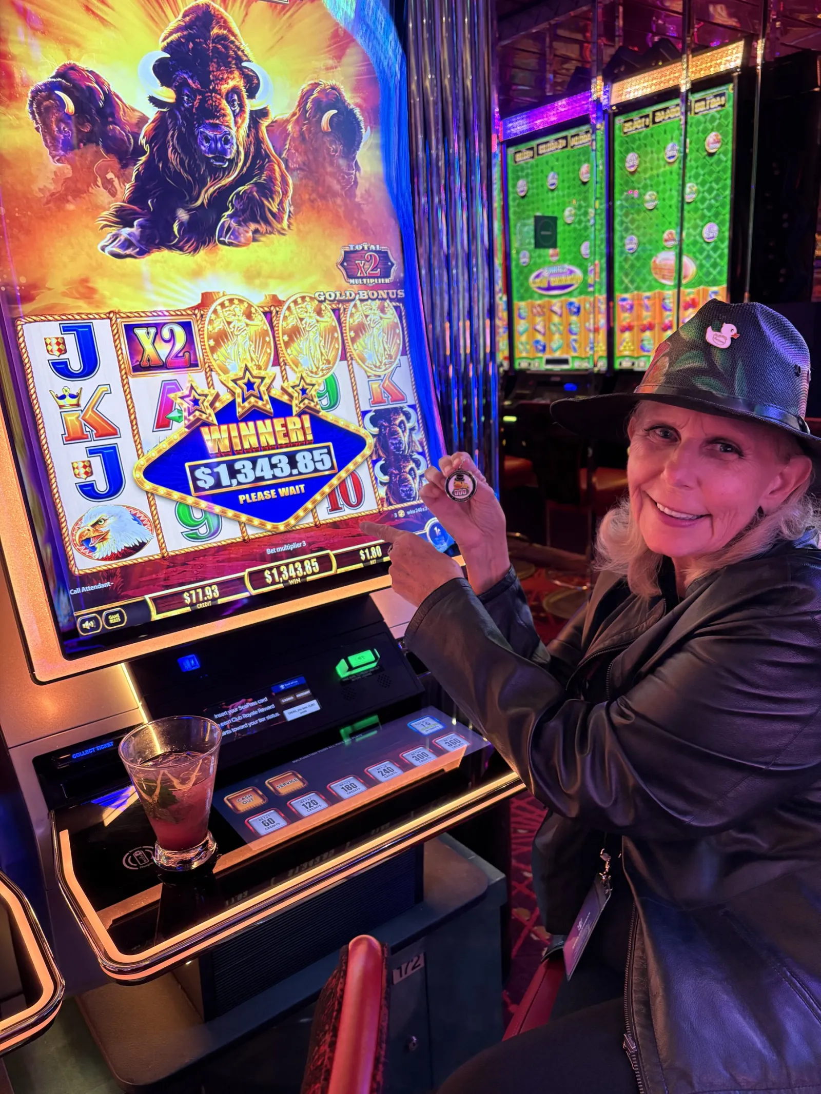 Jackpot Jill smiles beside a slot machine showing a $1,343.85 winner screen.