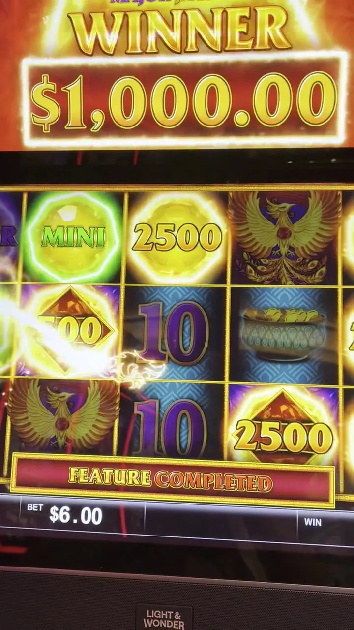 Slot machine screen celebrating a $1,000.00 winner during a bonus feature.