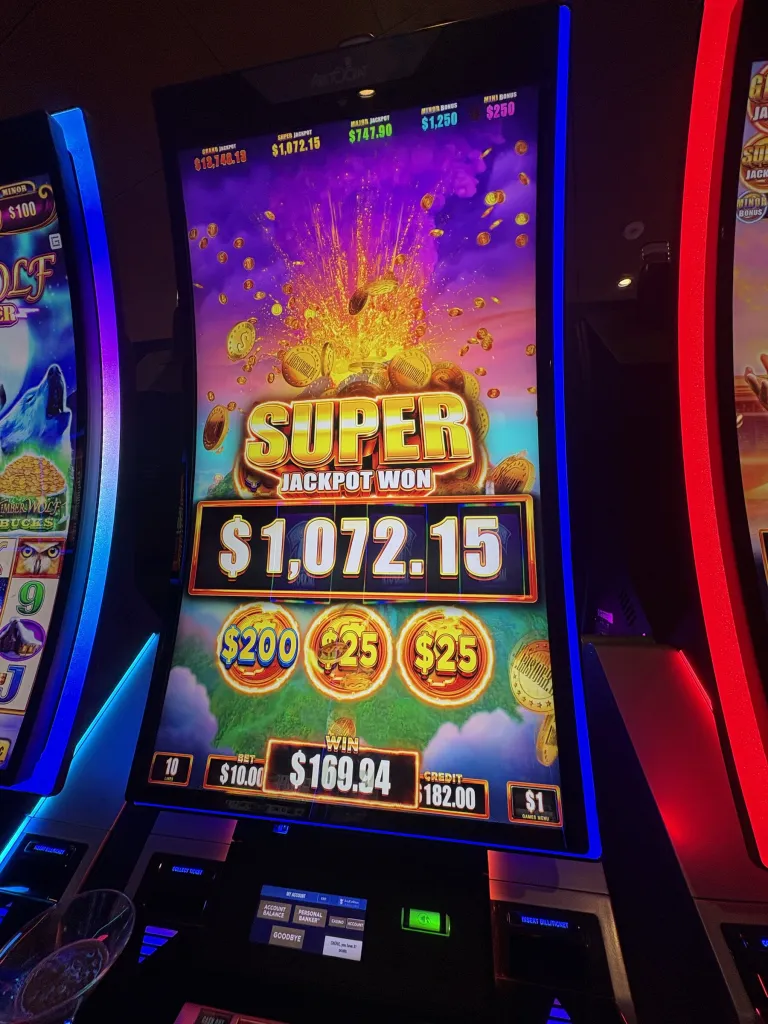 Slot machine screen showing Super Jackpot Won with a $1,072.15 prize.